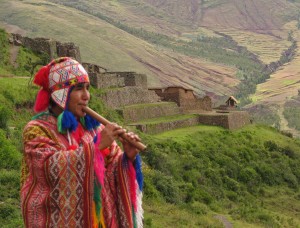Quetchua_musician_with_Inca_ruins_of_Pisac_in_background_Andes_Mts_Peru_copy